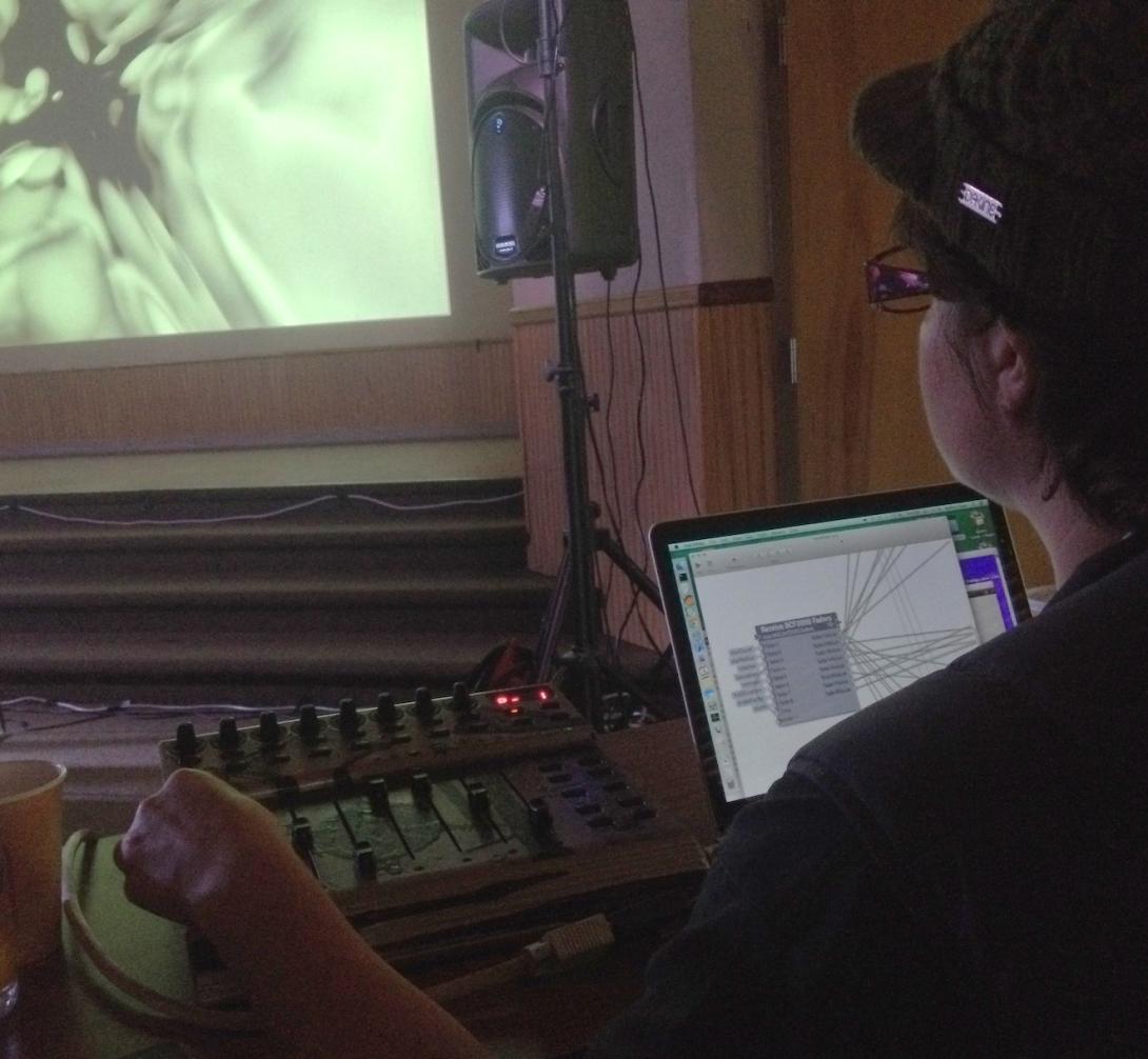 A photo of a person using Vuo to create live visuals for an electronic music performance