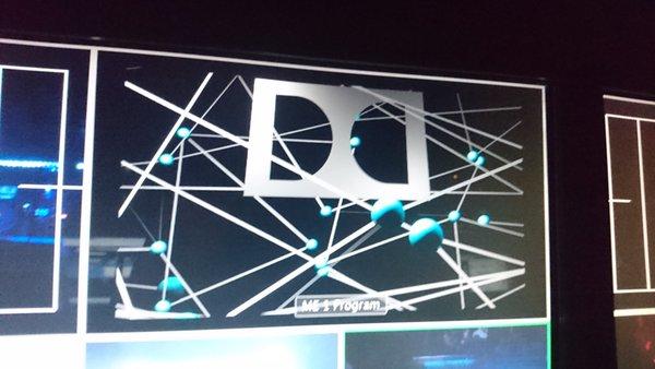 A photo of a computer display showing the Dolby logo and lines and spheres