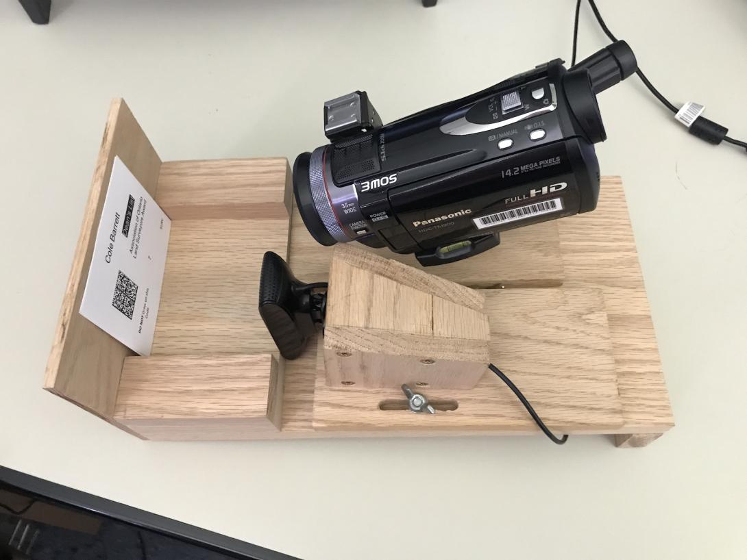 Video camera mounted on wood frame and pointed at barcode