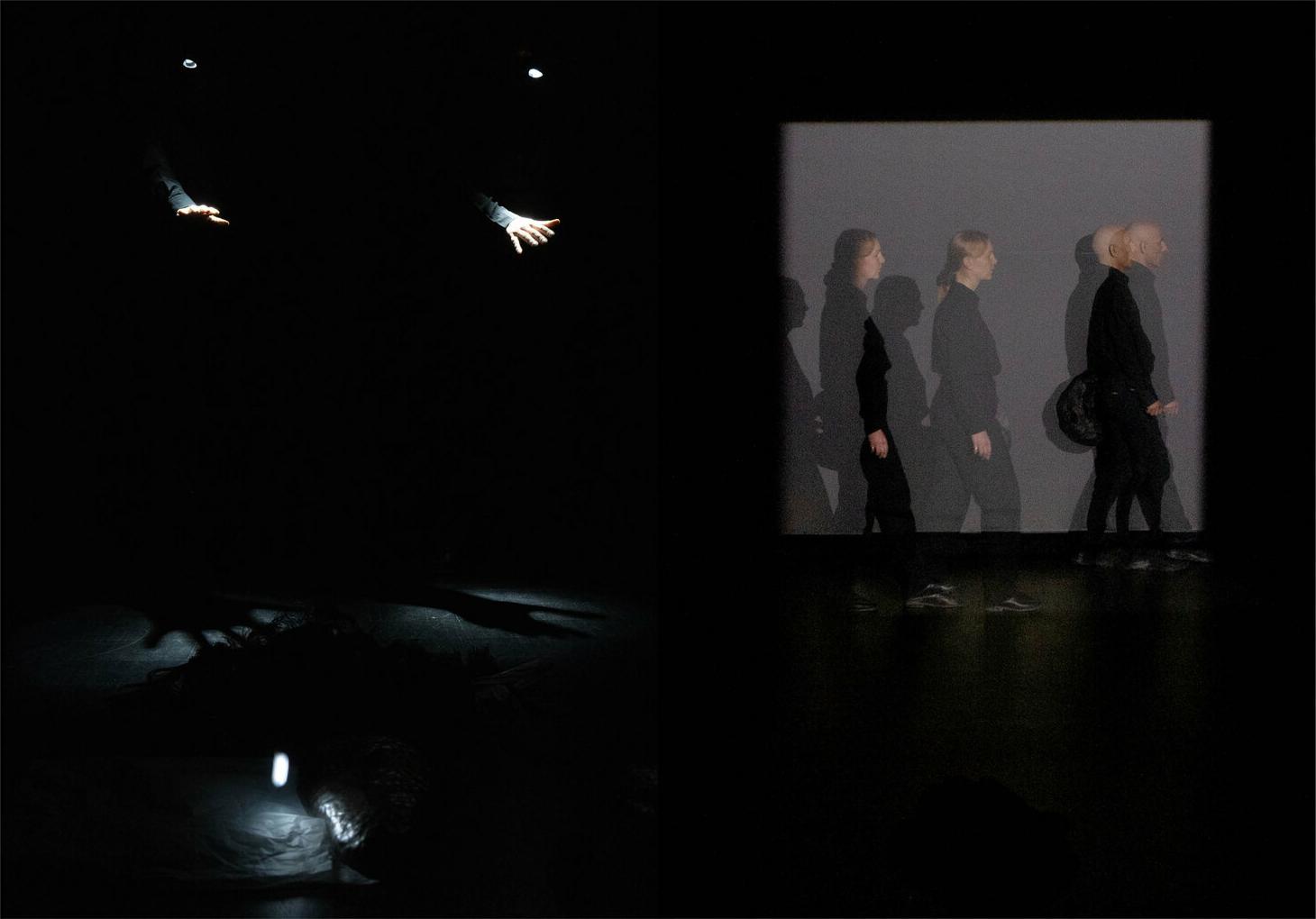 Still from 'Trust me tomorrow' showing a stage with a light on an unknown object in the foreground, two lights on disembodied hands in the back left while the back right shows two figures walking with an apparent time-lapse overlap.